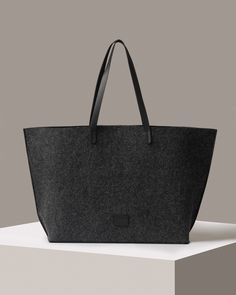 Felt at its finest – the Hana Merino Wool Felt Boat Bag showcases the natural beauty of our premium German-milled Merino wool felt and puts its strength and durability properties to work in this oversized east-west version of our Hana Tote. An upscale market tote or weekender travel bag that functions as well as it looks, the Hana Boat Bag can sling over the shoulder making for a unique and beautiful carryall. Trimmed with vachetta leather with an interior pocket and a snap closure.

 To add a little extra flare and make your bag even more unique, why not add one of our Fobs (https://graflantz.com/collections/keychains).

  

 Benefits of Merino Wool Felt

  
 * Sustainable, biodegradable, and renewable 
 * Odor, stain, heat, and dirt-resistant 
 * Oeko-Tex® Certified 
 * See all the benef Wool Rectangular Shoulder Bag For Travel, Rectangular Wool Shoulder Bag For Travel, Everyday Felt Tote Bag, Wool Tote Bag For Travel, Rectangular Wool Travel Bag, Wool Tote Bag For Everyday Use, Daily Use Wool Bag With Leather Handles, Daily Use Wool Bags With Leather Handles, Daily Wool Bag With Leather Handles