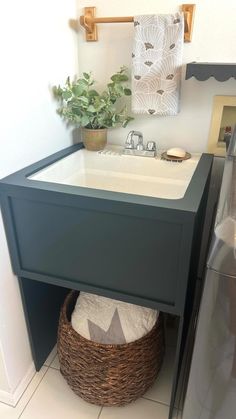 a bathroom sink with a basket underneath it