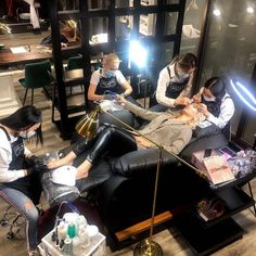 a group of people sitting around each other in a room with lights on the floor