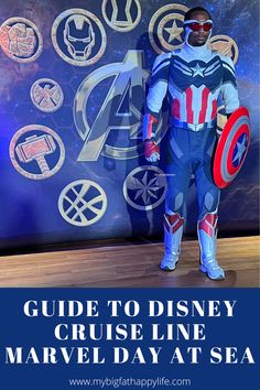 a man dressed as captain america standing in front of a wall with avengers symbols on it