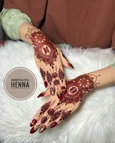 henna on the hands of a woman with red and gold designs in her hand