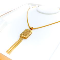 This 22k gold pendant, weighing 5.5 grams, features a luminescent rectangular design that exudes elegance and sophistication. The yellow gold finish enhances its luxurious and radiant appearance. Measuring 2.8 inches in length, this pendant is perfect for adding a touch of refined beauty to any necklace chain (chain not included). Ideal for those who appreciate exquisite craftsmanship and timeless style, this stunning pendant is a standout addition to any jewelry collection. PRODUCT DETAILS Gold Traditional Gold Square Pendant Jewelry, Rectangular Gold Jewelry For Celebration, Traditional Gold Necklace With Rectangular Pendant, Rectangular Gold Jewelry For Ceremonial Occasions, Rectangular Gold Ceremonial Jewelry, Rectangular Gold Necklaces For Wedding, Ceremonial Gold Rectangular Jewelry, Gold Rectangular Necklace For Wedding, Luxury Rectangular Jewelry For Ceremonial Occasions