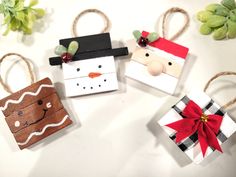 four small christmas gift bags with paper snowman, santa clause and reindeer on them