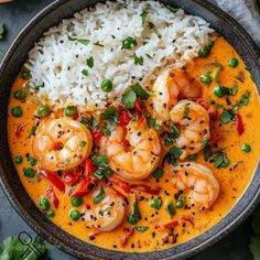 a bowl filled with shrimp and rice on top of a table