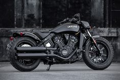 a black motorcycle parked in front of a building