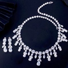 A luxurious two-piece bridal jewelry that will add elegance and sophistication to any wedding gown or formal ensemble! Adorned with intricately faceted cubic zirconia that capture the light from every angle with a perfectly translucent appeal, the pieces are platinum plated for a flawless finish which enhances the intricate detailing and conveys a modern take on old elegance. Necklace: 42cm (approx. 16.5") long with a secure fold-over closure (a 2" extension chain can be added upon request, plea White Crystal Bridal Sets With Diamond Cut, Elegant Crystal Bridal Sets With Rhinestones, Elegant Bridal Sets With Rhinestones And Crystal, Elegant Rhinestone Bridal Sets For Formal Occasions, Elegant Bridal Sets With Rhinestones For Formal Occasions, Wedding Jewelry Sets In Diamond White With Brilliant Cut, Elegant Diamond White Crystal Wedding Accessories, Diamond White Brilliant Cut Jewelry Sets For Wedding, Brilliant Cut Diamond White Jewelry Sets For Wedding