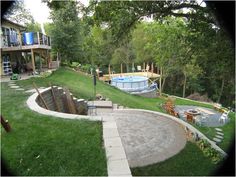 an above ground swimming pool in the middle of a lawn area with chairs and tables