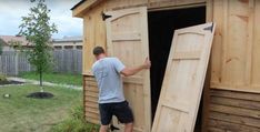 a man is opening the door to a shed that's being built into it