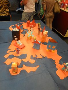 the table is covered with orange paper cutouts