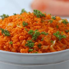 a white bowl filled with carrots and parsley