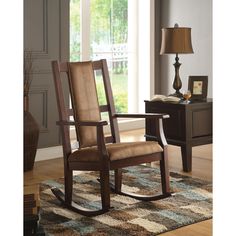 a rocking chair in a living room next to a lamp