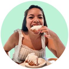 a woman sitting at a table eating food