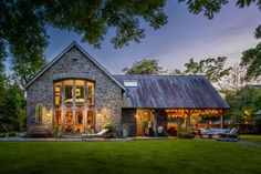 a stone house is lit up at night