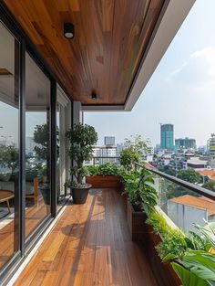 a balcony with potted plants and wooden floors