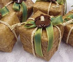 some brown wrapped straw bags with green ribbons