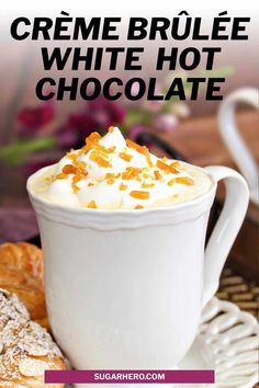 a white cup filled with whipped cream and topped with orange zest