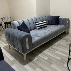 a grey couch sitting on top of a hard wood floor