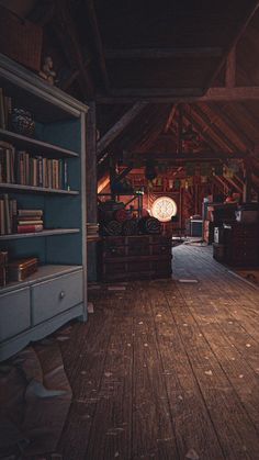 a room with wooden floors and shelves filled with books