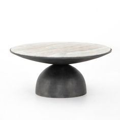 a white marble topped table with black metal base on an isolated surface, viewed from the front