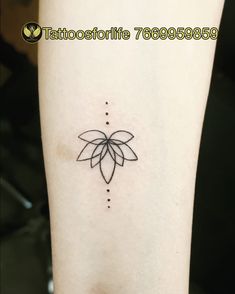 a small tattoo on the leg of a woman's left arm, with dots in it