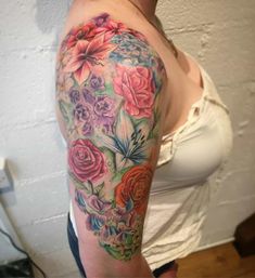 a woman's arm with flowers on it