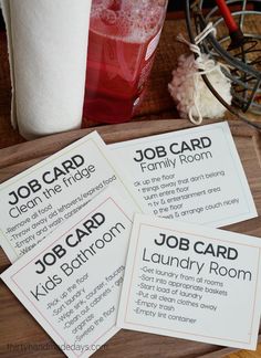 four job cards sitting on top of a wooden tray next to a cup and paper towel