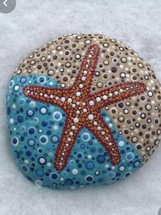 a rock with a starfish painted on it