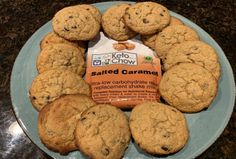 chocolate chip cookies arranged in a circle on a plate next to a packet of salted caramel