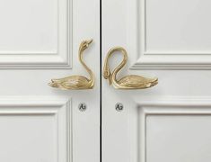 two brass swan hooks on the front door