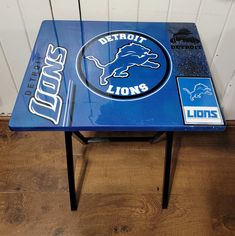 the detroit lions logo is painted on an end table