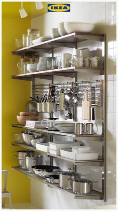 a metal shelf filled with lots of pots and pans