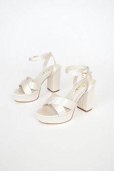 Lulus Exclusive! Kick your OOTN up a notch by slipping on the Lulus Selah Ivory Satin Ankle Strap Heels! Thick satin straps cross over a peep-toe upper, while an ankle strap wraps around ankle and secures with a gold buckle. 1"" toe platform. 4" wrapped block heel. Cushioned insole. Rubber sole has nonskid markings. Man made materials. Imported. Lulus | Selah Ivory Satin Ankle Strap Heels | Size 9. White Heels Aesthetic, Jennie Closet, Hoco Heels, Hoco Shoes, Ivory Heels, Dr Shoes, Cute Shoes Heels, Prom Heels, Heels Platform