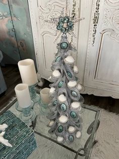 a decorated christmas tree sitting on top of a glass table