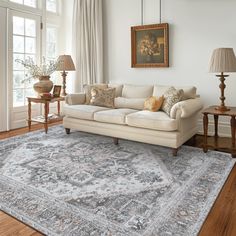 a living room filled with furniture and a large rug