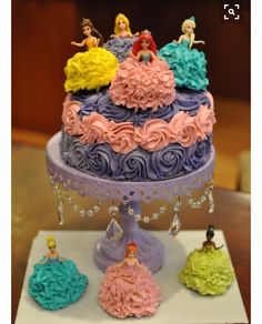 there is a cake with princess figures on it