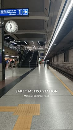 an empty metro station with people walking around