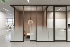 an office with glass walls and sliding doors