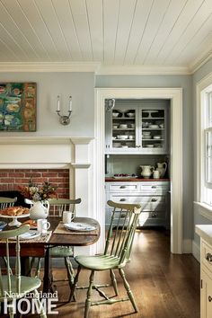 a dining room table and chairs in front of a fire place with a brick oven