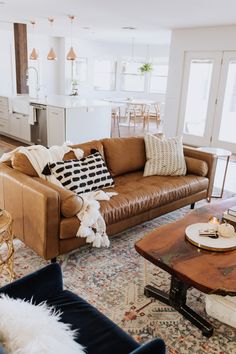 a living room filled with lots of furniture and decor on top of a wooden table