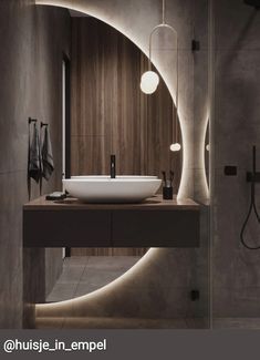 a bathroom with a sink, mirror and lights on the wall next to each other