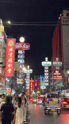 a busy city street filled with lots of neon signs