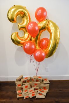 balloons and packages are on the floor in front of a sign that says 50