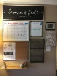 a bulletin board with calendars and magnets on it next to a wall mounted clock