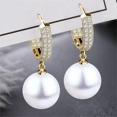 [High quality and hypoallergenic] Made of high quality brass and silver needle and Fine white stone ​The low sensitivity and high quality make it an excellent choice for people with sensitive skin.The brass material also makes it durable and resistant to tarnish. [Eye-catching design]The gift is another set of diamond-studded earrings, paired with white pearls for a stunning sense of luxury, simple earrings are a trend complement, wear them as a statement piece. [Comfortable and stylish] The lightweight stud size is suitable for everyday wear, neither too big nor too small. The clasp makes it super easy and comfortable to wear and hold. [Gift for Women 2023] It is perfect for women and is a great way to show gratitude to women. This is a great way to show your love for your mother, wife, f Elegant White Round Crystal Earrings, Hypoallergenic White Crystal Earrings, Elegant Hypoallergenic Crystal Earrings, White Round Crystal Earrings For Pierced Ears, Elegant Diamond White Hoop Earrings For Pierced Ears, White Classic Drop Crystal Earrings, White Cubic Zirconia Drop Pearl Earrings, Classic White Drop Crystal Earrings, Diamond White Dangle Pearl Earrings