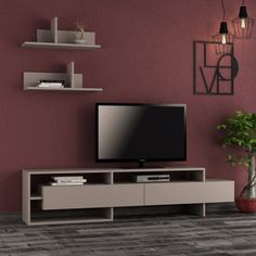 a living room scene with focus on the entertainment center and large screen tv mounted to the wall