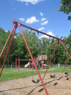 an empty playground with swings and slides