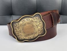 "LENGTH - 1-1/2\" Wide (38 millimeters wide) Elevate your men's western fashion with our exceptional Handmade Genuine Leather Western Belt. Crafted by our experts, this Cowboy Style belt is more than a simple accessory designed for the cowboy at heart. It's a rugged, one-of-a-kind statement piece needed in your wardrobe. BUCKLE - Handmade western style cowboy buckle made. Add your own personalization to customize your belt! SIZE - For the best fit, pick your belt at 2\" longer than your waist size. (For example, if you wear a size 34 pants, you should order a size 36 belt) 100% MONEY BACK GUARANTEE - Make a statement with our Traditional Cowboy Belt--shop with full comfort and security of our Money Back Guarantee system now and experience the perfect fusion of Genuine Leather, Cowboy Style Classic Brown Belt Buckles For Western-themed Events, Engraved Brown Belt Buckles For Western-themed Events, Western Belt Buckles For Rodeo, Cowboy Buckle, Leather Belt Buckle, Nice Belts, Cowboy Belt, Mens Cowboy, Western Belt