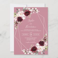 a pink wedding card with burgundy flowers and greenery