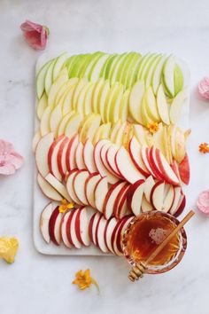 an image of apple slices and honey on a plate