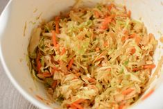 a white bowl filled with coleslaw and carrots